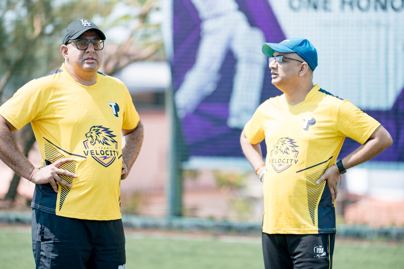 Two leaders in tactical discussion — Velocity jerseys, One Honor banner