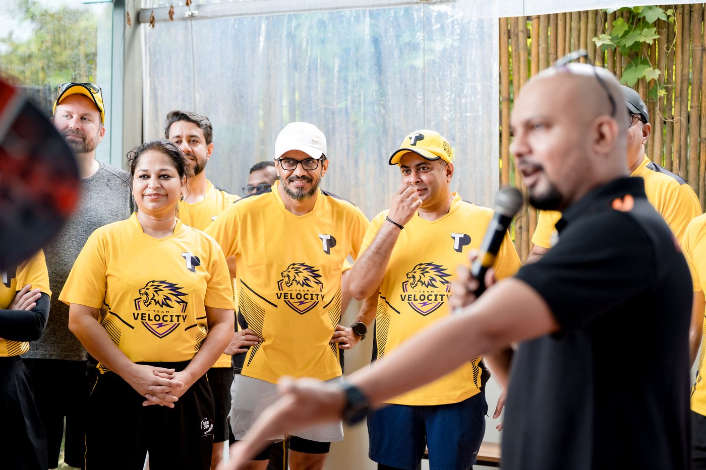 Team Velocity briefing — woman leader in front row