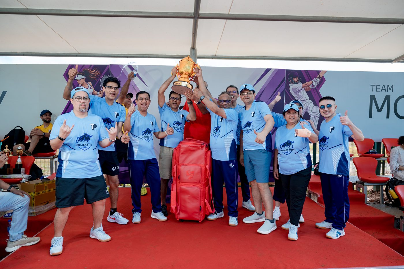 Team Momentum lifting the One Team Cup trophy